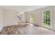 Living room with hardwood floors, neutral paint, and natural light from two large windows at 4179 Westchester Ne Xing, Roswell, GA 30075