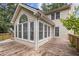 Light-filled sunroom boasts many windows and access to a wooden deck, perfect for enjoying the outdoors at 4179 Westchester Ne Xing, Roswell, GA 30075