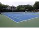 Well-maintained community tennis court with a view of beautiful houses and mature trees at 4179 Westchester Ne Xing, Roswell, GA 30075