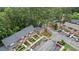 Aerial view of townhomes with mature landscaping, ample parking, and surrounding lush green trees at 49 Country Ct, Alpharetta, GA 30005