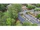 Aerial view of the townhome exteriors showing common parking, landscaping, and surrounded by trees at 49 Country Ct, Alpharetta, GA 30005