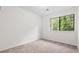 Empty bedroom with a large window showing exterior trees at 49 Country Ct, Alpharetta, GA 30005