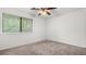 Empty bedroom showcasing the large window and ceiling fan at 49 Country Ct, Alpharetta, GA 30005
