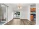 Dining area featuring hardwood floors, contemporary lighting, and sliding door to the patio at 49 Country Ct, Alpharetta, GA 30005
