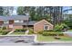 Well-maintained townhouse with brick accents, mature trees, and landscaped grounds at 49 Country Ct, Alpharetta, GA 30005