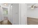Bright hallway with wood-look flooring and closet leading to a bedroom with a ceiling fan at 49 Country Ct, Alpharetta, GA 30005