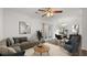 Bright living room with modern furniture, ceiling fan, and sliding glass door to the exterior at 49 Country Ct, Alpharetta, GA 30005