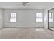 Spacious bedroom with carpet, ceiling fan, and large windows, providing natural light at 6035 Wintergreen Rd, Norcross, GA 30093
