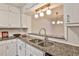 Close-up of the kitchen's granite countertops and double sink with view through to the dining room at 6035 Wintergreen Rd, Norcross, GA 30093