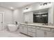 Elegant bathroom with a freestanding tub, granite counters, and a large mirror at 95 Old Town Rd, Dacula, GA 30019