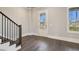 Bright entryway featuring hardwood floors, staircase, and glass paneled exterior door at 95 Old Town Rd, Dacula, GA 30019