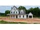 New construction home with white siding, black trim, and welcoming front porch at 95 Old Town Rd, Dacula, GA 30019