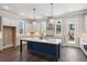Modern kitchen featuring large island, custom cabinetry, and stainless steel appliances at 95 Old Town Rd, Dacula, GA 30019