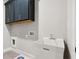 Functional laundry room with a utility sink, hanging cabinets, and tile floors at 95 Old Town Rd, Dacula, GA 30019