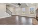 Open-concept living room with hardwood floors, fireplace, and staircase with iron spindles at 95 Old Town Rd, Dacula, GA 30019