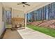 Covered patio featuring an outdoor fireplace and views of the wooded backyard at 95 Old Town Rd, Dacula, GA 30019