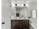 Bright bathroom with dark cabinets, double sinks, and stylish light fixtures at , Lawrenceville, GA 30044