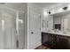 Bathroom featuring a glass enclosed shower, dark cabinets, and double sinks at , Lawrenceville, GA 30044