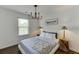 Relaxing bedroom with stylish chandelier, hardwood floors, and natural light, ideal for a peaceful and comfortable resting area at , Lawrenceville, GA 30044