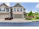 Charming two-story townhome with a brick facade, a two-car garage, and manicured landscaping at , Lawrenceville, GA 30044