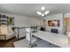 Open home office with modern lighting, an accent rug, comfortable armchair and long work space provides a tranquil remote setting at , Lawrenceville, GA 30044