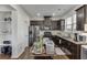 Kitchen features stainless steel appliances, granite counters, dark wood cabinets and floors, and a rolling bar at , Lawrenceville, GA 30044