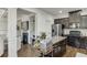 Kitchen with stainless steel appliances, granite counters, dark wood cabinets, and view to living room at , Lawrenceville, GA 30044