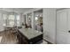 Kitchen with granite island, pendant lighting, stainless steel appliances, and dark wood cabinets and floors at , Lawrenceville, GA 30044