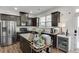 Kitchen with stainless steel refrigerator, granite counters, island, and dark wood cabinets and floors at , Lawrenceville, GA 30044