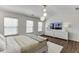 Bright main bedroom with modern lighting, hard wood floors, and a large television at , Lawrenceville, GA 30044