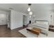 Airy main bedroom featuring hardwood floors, a comfortable bed, modern lighting, and easy access to an ensuite bathroom and closets at , Lawrenceville, GA 30044