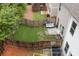 Aerial view of backyard features wooden fence, patio seating, grill, and green grass at 109 Camden Park Dr, Woodstock, GA 30188
