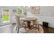 Charming dining area featuring a wooden table with chairs, a window view, and wall decor at 109 Camden Park Dr, Woodstock, GA 30188