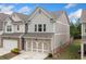 Beautiful exterior elevation of townhome with garage, neutral colors, and pristine landscaping at 109 Camden Park Dr, Woodstock, GA 30188