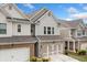 Lovely townhome showcases brick and siding facade, complimented by a two-car garage and manicured landscaping at 109 Camden Park Dr, Woodstock, GA 30188