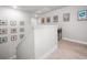 Upstairs hallway with carpet, many art decorations, and white walls at 109 Camden Park Dr, Woodstock, GA 30188