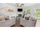 Cozy living room with comfortable seating, a fireplace, and a view of the backyard at 109 Camden Park Dr, Woodstock, GA 30188