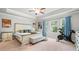 Spacious main bedroom with tray ceiling, and seating area near sunlit windows at 109 Camden Park Dr, Woodstock, GA 30188