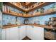 Walk-in pantry with blue floral wallpaper, wood countertops and shelving, and white cabinets at 109 Camden Park Dr, Woodstock, GA 30188