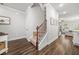 Stairway features wood handrail, carpeted steps, and dark wood floors in a nicely decorated entryway at 109 Camden Park Dr, Woodstock, GA 30188