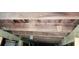 Looking up to exposed wood beams under the house at 119 E Johnson St, Temple, GA 30179