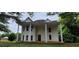 Two-story home featuring a large front porch supported by stately columns at 119 E Johnson St, Temple, GA 30179