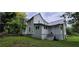 Exterior view of the side of a home with white siding and a small roof addition above the entrance at 119 E Johnson St, Temple, GA 30179