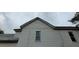 Side view of a home featuring white siding, several windows, and a roofline against a cloudy sky at 119 E Johnson St, Temple, GA 30179