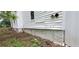 Siding on the exterior of home and foundation with grass and dirt at 119 E Johnson St, Temple, GA 30179