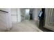 A glimpse down the hallway, featuring stairs, and aged floors in need of repair at 119 E Johnson St, Temple, GA 30179