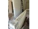 A worn staircase with wooden banisters leads to the upper level of this home at 119 E Johnson St, Temple, GA 30179