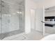 A modern bathroom with a glass-enclosed shower featuring marble tile and a view of a bedroom through the door at 3330 Carswell Bnd, Cumming, GA 30028