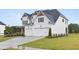 Inviting two-story home with a three-car garage and well-manicured front lawn at 3330 Carswell Bnd, Cumming, GA 30028