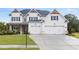 Beautiful home featuring a three-car garage, lush lawn, and charming stonework at 3330 Carswell Bnd, Cumming, GA 30028